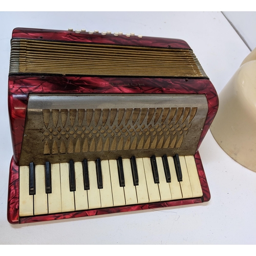 197 - A mid century painted metal teapot and a Hohner piano accordion in a mottled red case
Location:7.4