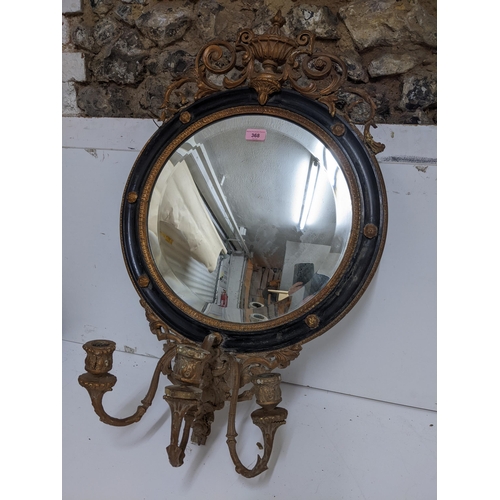 198 - A 19th century gilt gesso wood and black girandole mirror, circular frame surmounted by scrolled lea... 