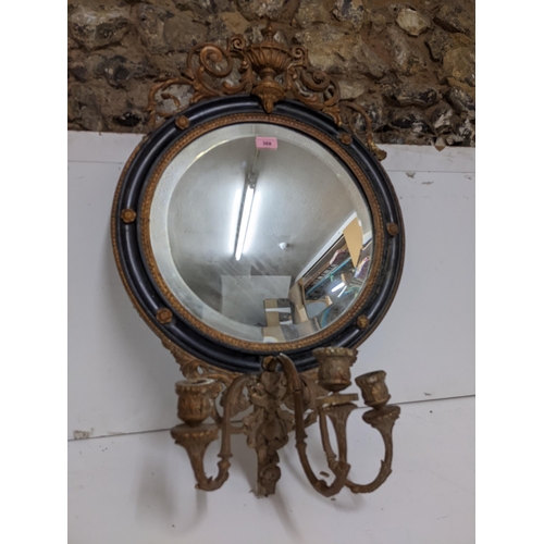 198 - A 19th century gilt gesso wood and black girandole mirror, circular frame surmounted by scrolled lea... 