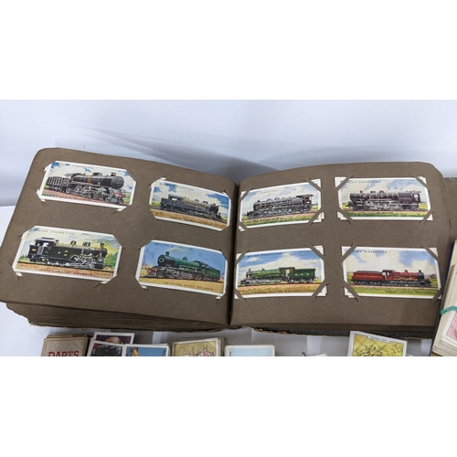 202 - A collection of cigarette cards to include an album containing mainly complete sets to include Airme... 