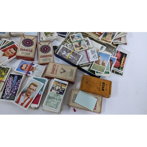 202 - A collection of cigarette cards to include an album containing mainly complete sets to include Airme... 