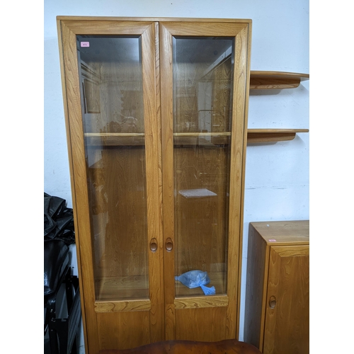 206 - An Ercol Windsor style full height display cabinet, three glass interior shelves and twin glazed dis... 