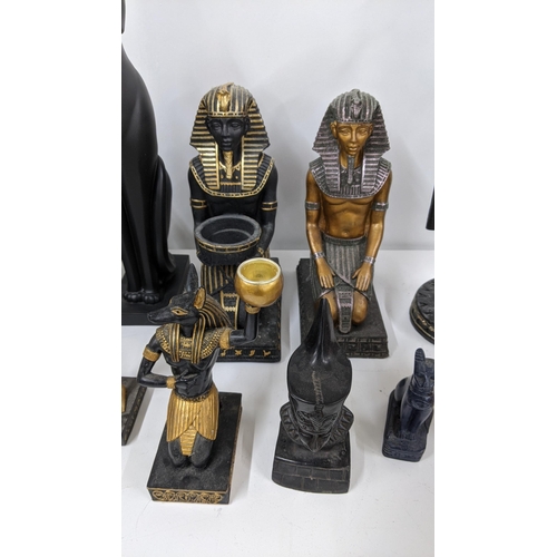 110 - A mixed group of classical Egyptian Gods and Goddess figurines, together with an Egyptian cat sculpt... 