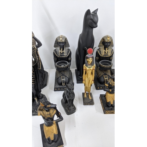 110 - A mixed group of classical Egyptian Gods and Goddess figurines, together with an Egyptian cat sculpt... 