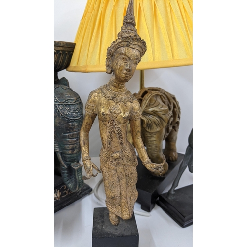 112 - A mixed lot to include a cast metal bronze coloured Thai figurine, a resin pierced elephant lamp, A/... 