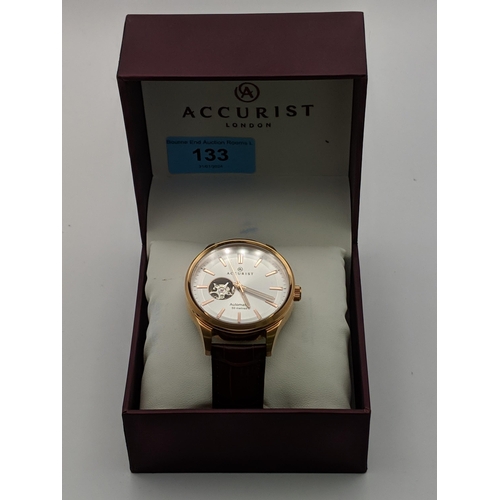 133 - An Accurist automatic gents stainless steel wristwatch with a silver coloured face with rose gold co... 