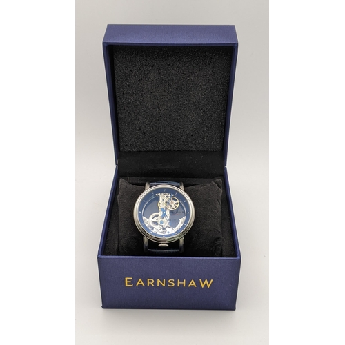 140 - An Earnshaw automatic stainless steel gents wristwatch with a clear face, visible movement, on a dar... 