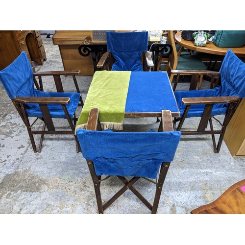 162 - An early to mid 20th century folding card table, the top with a blue baize, and four matching wooden... 