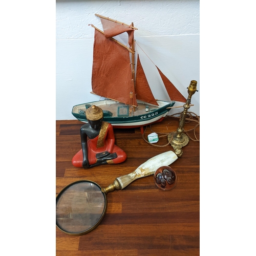 262 - Collectables to include a painted wooden model boat, a resin Buddha, a large magnifying glass and pa... 