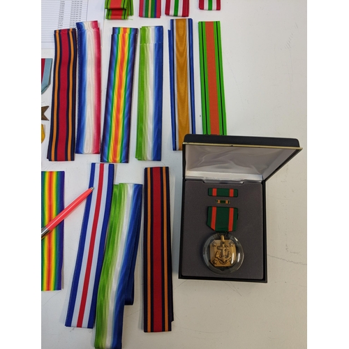 295 - War medal ribbons and a department of defence US plaque, a cased achievement medal embossed with an ... 