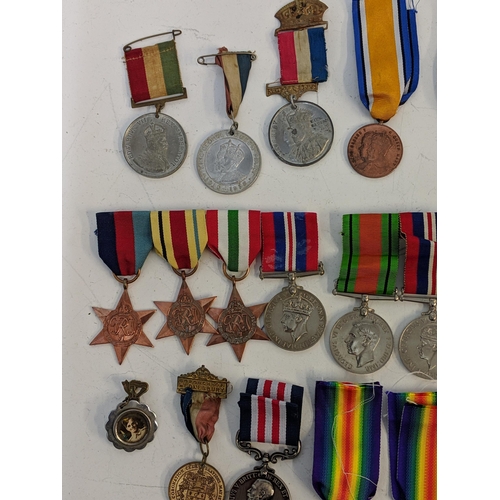 297 - Mixed WWI and WWII service medals, to include British war, Stars, a copy and dog tab 'Holdstock', Lo... 