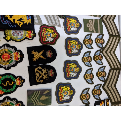 299 - Cloth military badges and cap badges to include Royal Army Veterinarian Corps, Royal Hussairs, RAF R... 