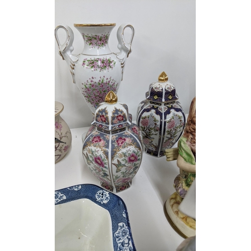 214 - Mixed ceramics to include a variety of figurines, a pair of twin handled ginger jars and paperweight... 