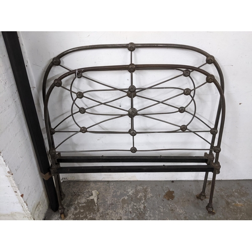 370 - Victorian cast iron head and foot boards, on castors, with two iron side slats Location:G