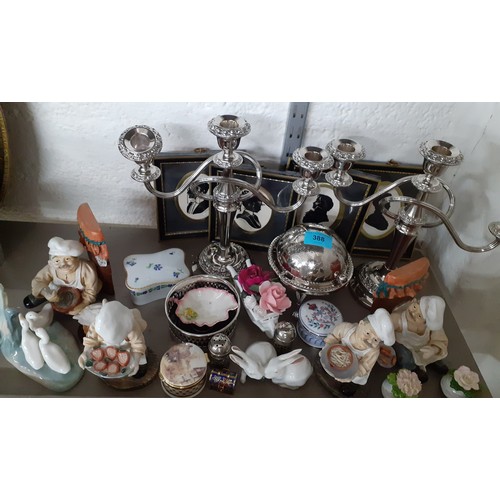 388 - A mixed lot comprising silver plated items to include a pair of candelabras, resin ornaments, trinke... 