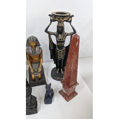 110 - A mixed group of classical Egyptian Gods and Goddess figurines, together with an Egyptian cat sculpt... 