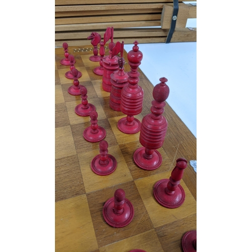 121 - A mixed lot to include a wooden chessboard, 50cm x 50cm, together with bone carved chess pieces, alo... 