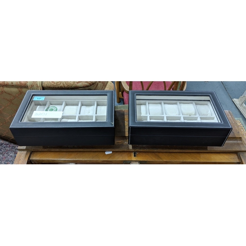 147 - Two wristwatch display cases with space for ten watches per case, leather bound with white stitching... 