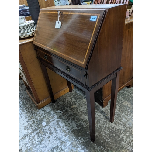 161 - An inlaid mahogany bureau, fall flap revealing a single shelf to interior, above a drawer, on square... 