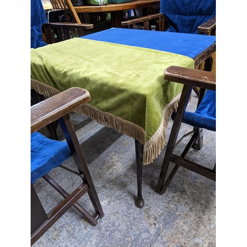 162 - An early to mid 20th century folding card table, the top with a blue baize, and four matching wooden... 