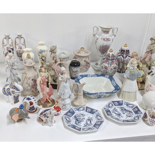 214 - Mixed ceramics to include a variety of figurines, a pair of twin handled ginger jars and paperweight... 