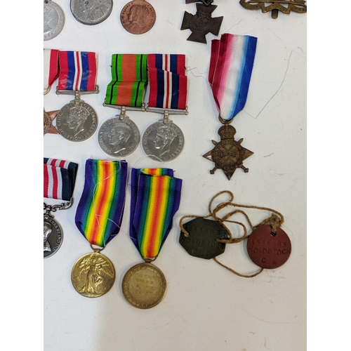 297 - Mixed WWI and WWII service medals, to include British war, Stars, a copy and dog tab 'Holdstock', Lo... 