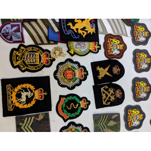 299 - Cloth military badges and cap badges to include Royal Army Veterinarian Corps, Royal Hussairs, RAF R... 