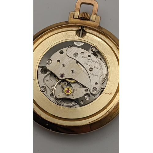 7 - A vintage Oris gold plated open faced pocket watch having a silvered dial with a date aperture 
Loca... 