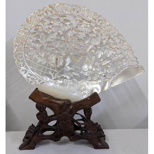 87 - A Chinese carved and pierced Mother of Pearl shell mounted on a stand 
Location:6.1