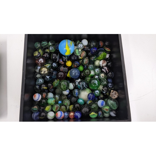 90 - A selection of various loose marbles together with a pair of crystal cut decanter stoppers, containe... 