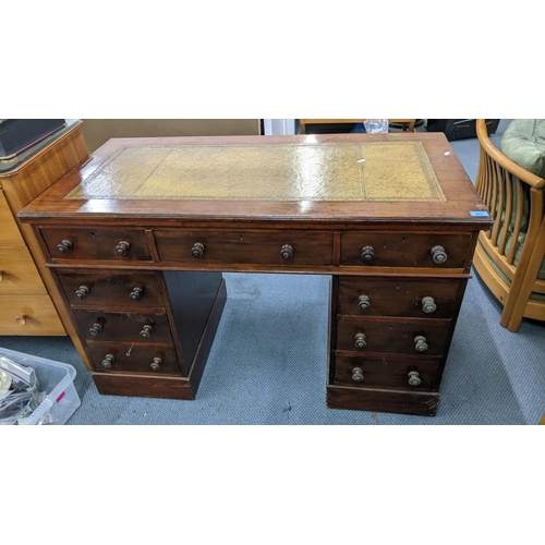 225 - A Victorian mahogany twin pedestal writing desk having a green leather topped scriber and nine drawe... 