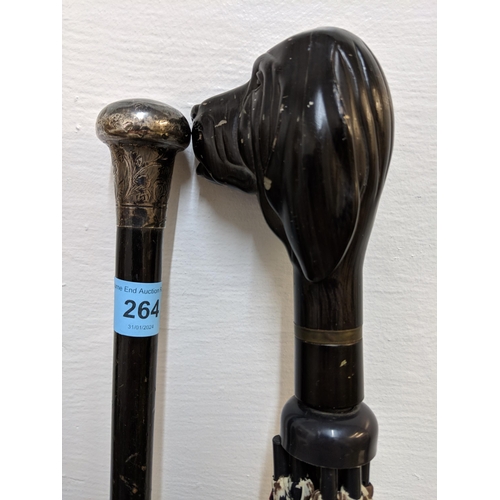 264 - A silver topped walking stick and an umbrella with a dog head handle, Aramis, Location:A2F