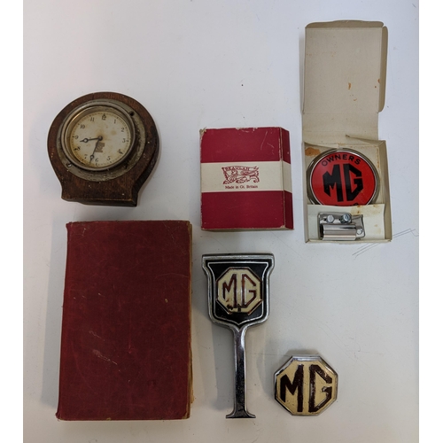 323 - M G related items to include a workshop manual 1955, three badge and Smith clock, Location:A2M