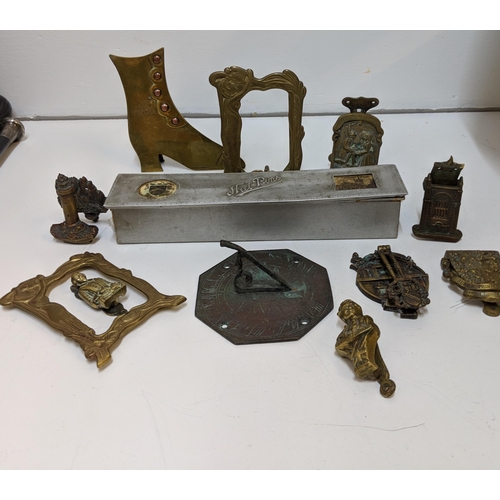 324 - Brass in include small door knockers and sundial, two framed 19th century boot plaques and a hat pin... 