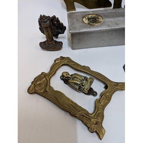 324 - Brass in include small door knockers and sundial, two framed 19th century boot plaques and a hat pin... 