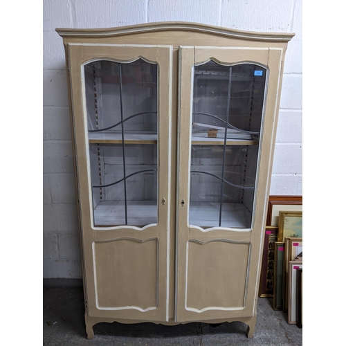 332 - A painted display cabinet with twin leaded display doors, three white painted adjustable shelves, on... 