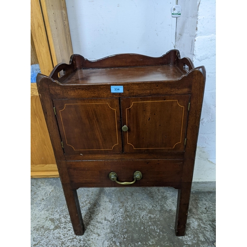 334 - A Georgian mahogany tray topped bedside commode, twin cupboard doors with inlaid stringing above a s... 