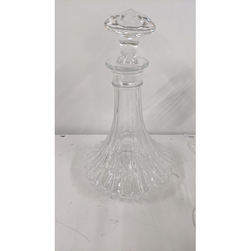 359 - A mixed lot to include crystal cut glassware to include two decanters, various drinking glasses alon... 