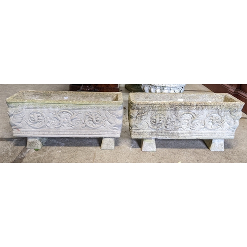 377 - A pair of reconstituted stone garden trough planters having moulded Grecian style decoration, raised... 