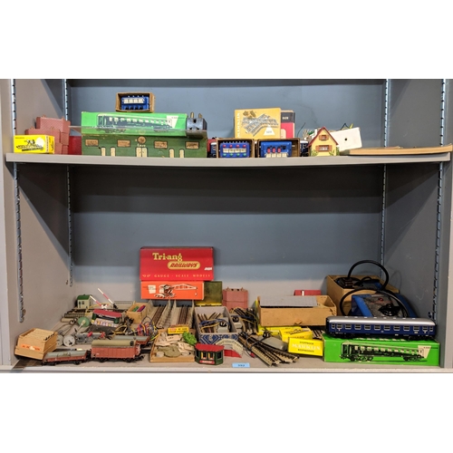 392 - A large quantity of mixed rolling stock and railway buildings and accessories to include, Tri-ang, M... 