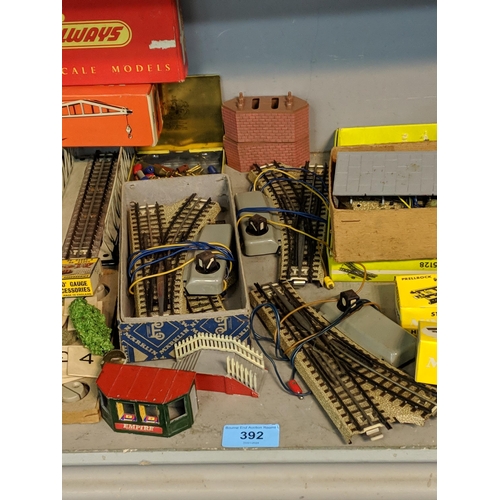 392 - A large quantity of mixed rolling stock and railway buildings and accessories to include, Tri-ang, M... 