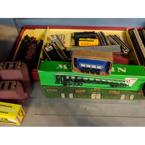 392 - A large quantity of mixed rolling stock and railway buildings and accessories to include, Tri-ang, M... 