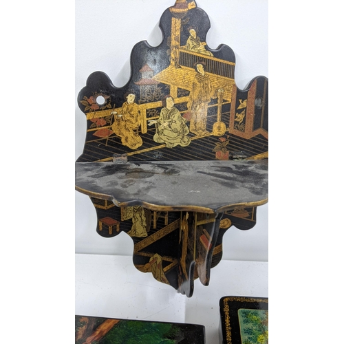 412 - Mixed black lacquered items to include a Chinese black lacquered folding wall hanging shelf and othe... 