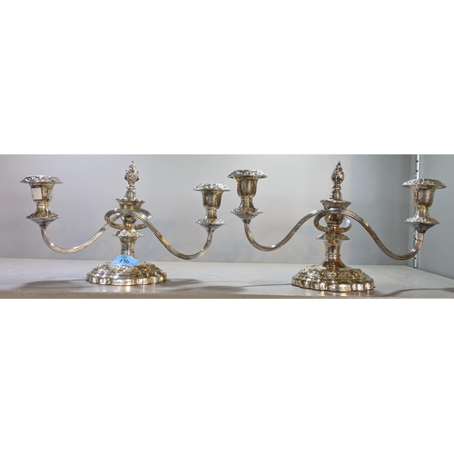 430 - A pair of silver plated, twin handled candelabras on weighted elaborate bases, 18cm, Location:4.1