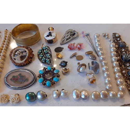 99 - A quantity of vintage costume jewellery to include a carved ivory style necklace with matching earri... 