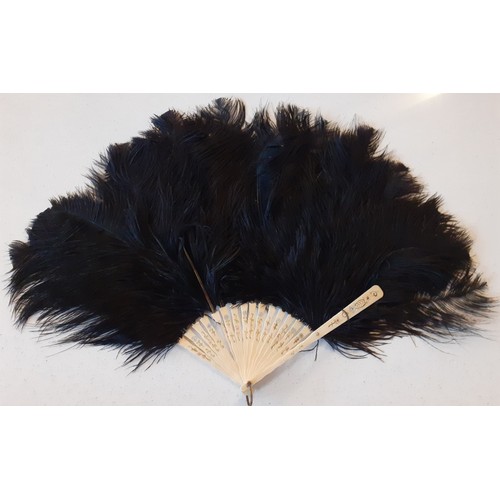 140 - An early 20th Century black ostrich feather 18 wand fan A/F, a 1930's glove envelope pouch containin... 