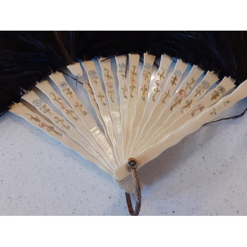 140 - An early 20th Century black ostrich feather 18 wand fan A/F, a 1930's glove envelope pouch containin... 