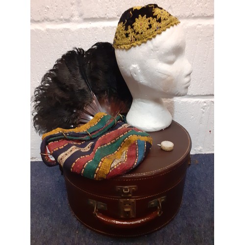 147 - A mixed lot comprising a black velvet and beaded cap with gold metallic thread, a vintage brown leat... 