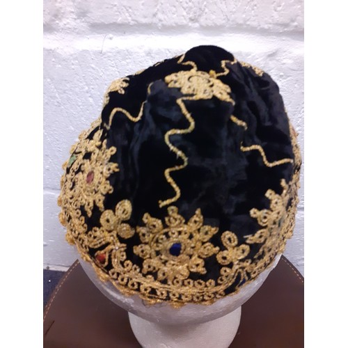 147 - A mixed lot comprising a black velvet and beaded cap with gold metallic thread, a vintage brown leat... 