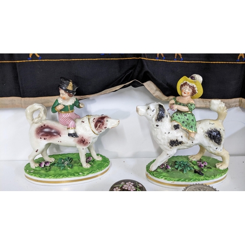 25 - Two early/mid 19th century Bloor Derby ornaments of children and dogs A/F, together with a white met... 